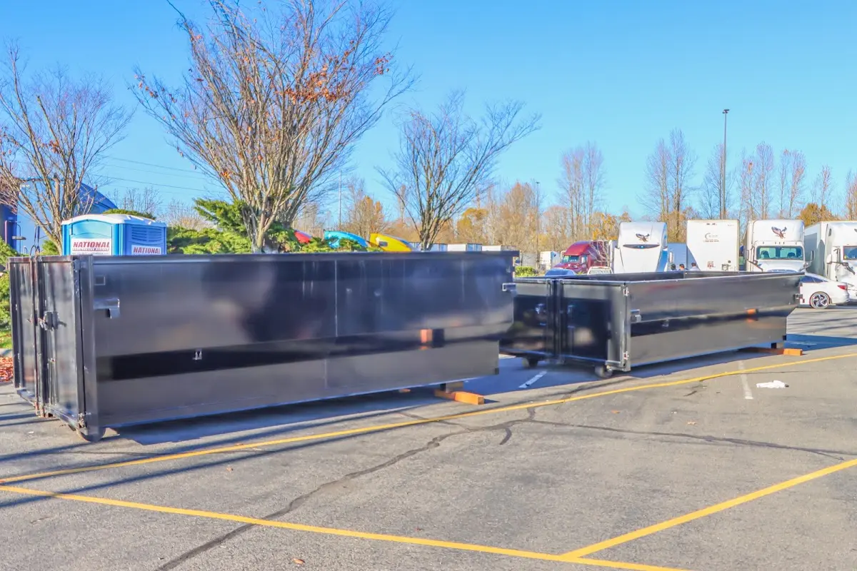 Professional dumpster rental service with roll-off container on residential driveway in Bath